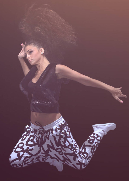 young woman jumping in the style of street dance - Foto, Bild