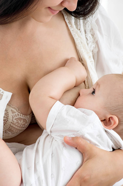 Mother breast feeding her infant - Фото, изображение