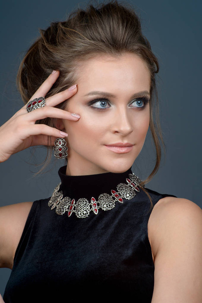luxury jewelry and fashion concept. A model with earrings necklace and ring on gray background - Fotografie, Obrázek