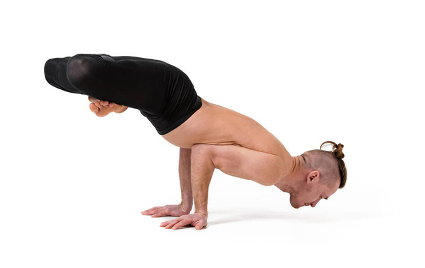  Yoga teacher doing exercises on yoga. Isolated over white background - Foto, afbeelding