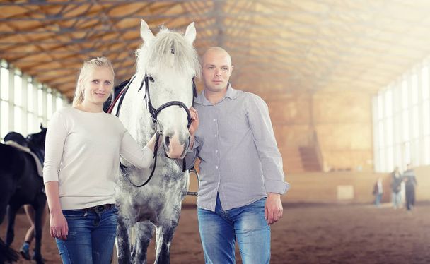 People on a horse training in a wooden arena - Fotoğraf, Görsel