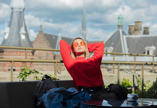 girl in orange sunglasses at roof in Amsterdam - Photo, Image