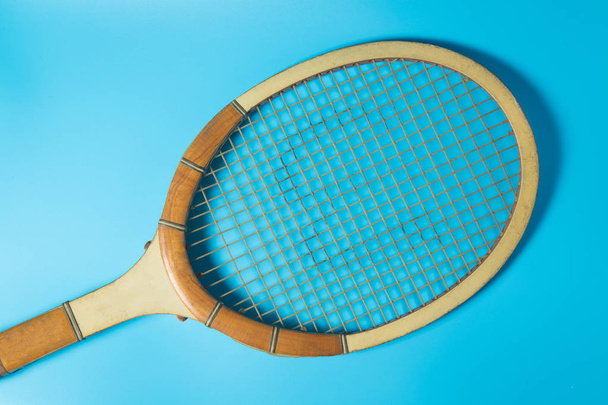 Raqueta de tenis sobre fondo azul. Equipamiento deportivo. Puesta plana
. - Foto, imagen