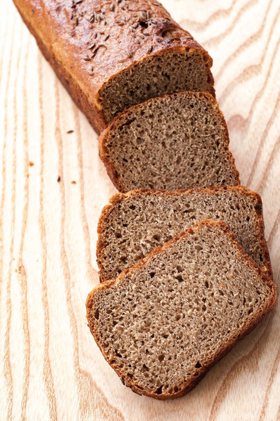 Čerstvě upečený chléb žitný. Plátky na dřevěné. Pohled shora. Detailní záběr. - Fotografie, Obrázek