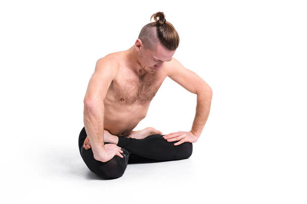 Strong man practicing yoga doing breathing exercises against white background - Foto, Imagem