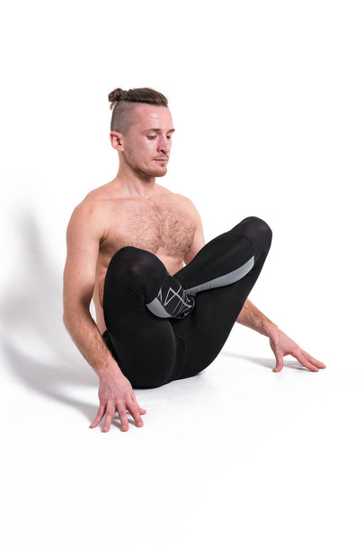 Strong man practicing yoga,wearing black sportswear.  - Fotografie, Obrázek