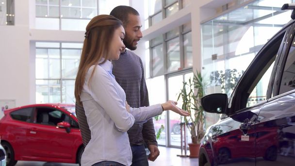 Couple chooses car at the dealership - Photo, Image