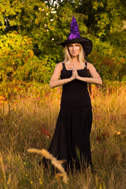 Felice femmina in costume di Halloween praticando posizioni yoga
  - Foto, immagini