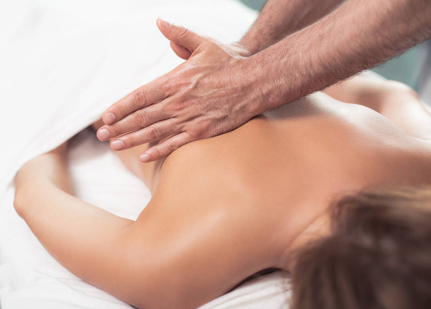 Masseur doing therapeutic massage on lady back - 写真・画像