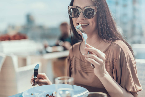 Happy girl tasting appetizing meal with fork - Zdjęcie, obraz