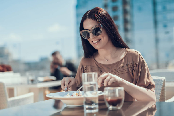 Cheerful lady eating delicious foodin cafe - Photo, image