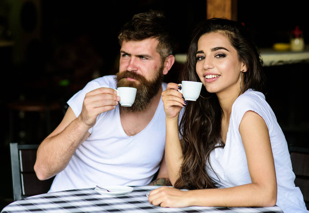 Couple in love drink black espresso coffee in cafe. Couple enjoy hot espresso. Drinking black coffee has numerous health benefits loaded with antioxidants and nutrients. Pleasant coffee break - Zdjęcie, obraz