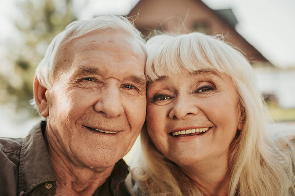 Portrait of cheerful aged man and woman - Fotó, kép