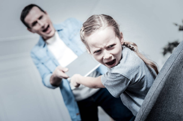 Naughty girl irritating parents - Foto, immagini