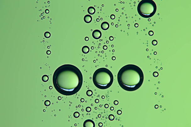 green wet background, raindrops on window glass, concept of autumn weather - Foto, Imagem