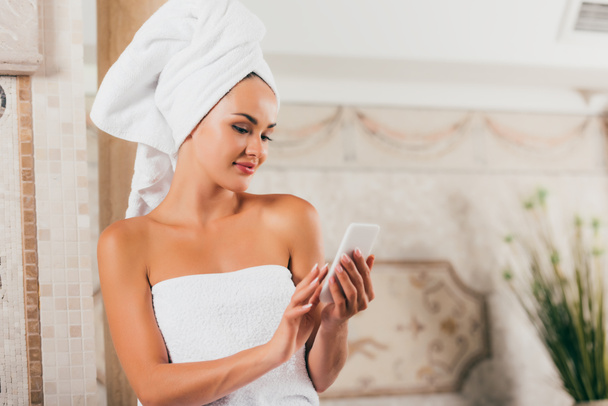 beautiful woman using smartphone at spa salon - Photo, Image
