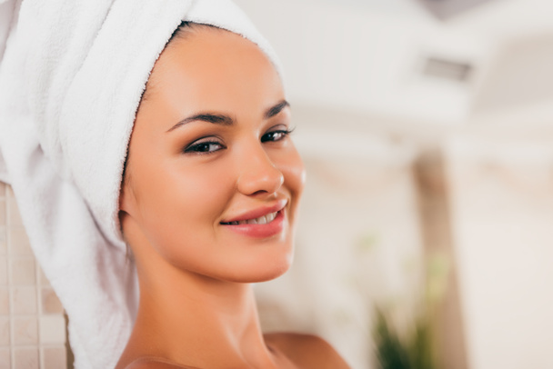 happy woman relaxing with towel on head at spa center - Photo, Image