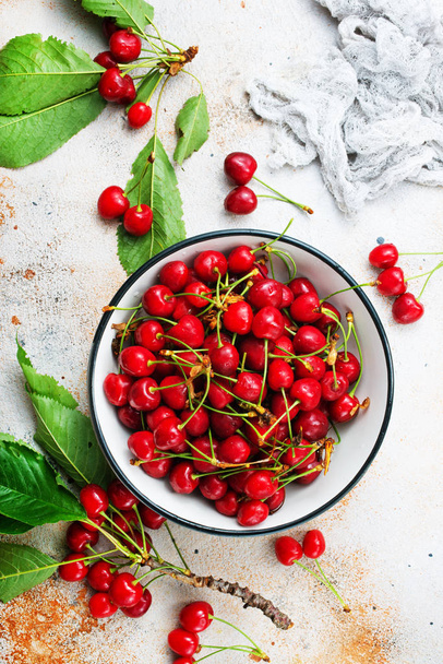 ripe cherries in white bowl on table - Fotoğraf, Görsel