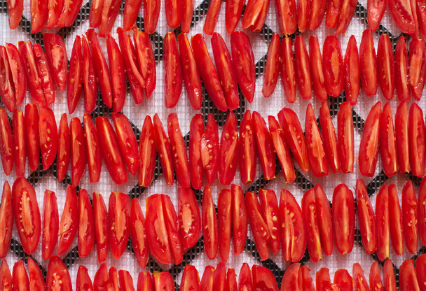 sliced red tomatoes, stacked in rows, ready to salad or to dry and dehydrated, top view, closeup - Photo, Image