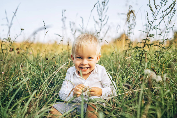 Cute little baby boy having fun outdoor - Fotó, kép