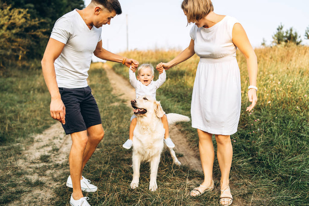Happy young family with dog having  fun outdoor - Foto, Bild