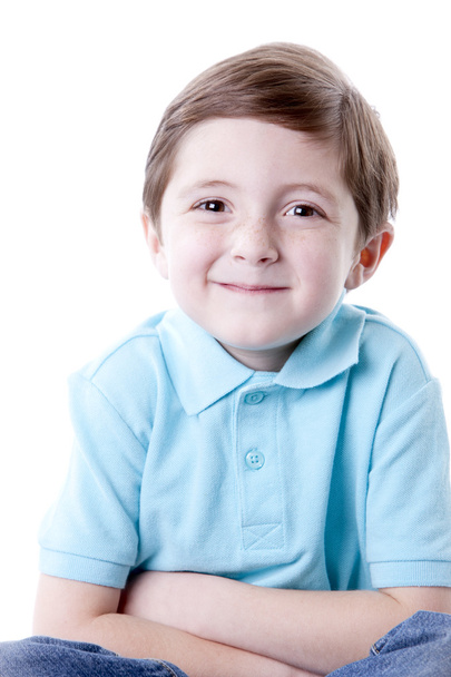 Smiling caucasian little boy sitting cross legged with his arms crossed - Valokuva, kuva