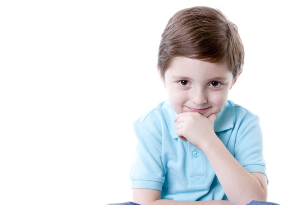 Smiling caucasian little boy with his hand on his chin - Φωτογραφία, εικόνα