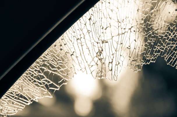 Vintage tone close-up outside view broken passenger window car smashed by thief or accident. Damaged glass from car theft. Motor Vehicle Insurance Claim Themed concept background. - Photo, Image