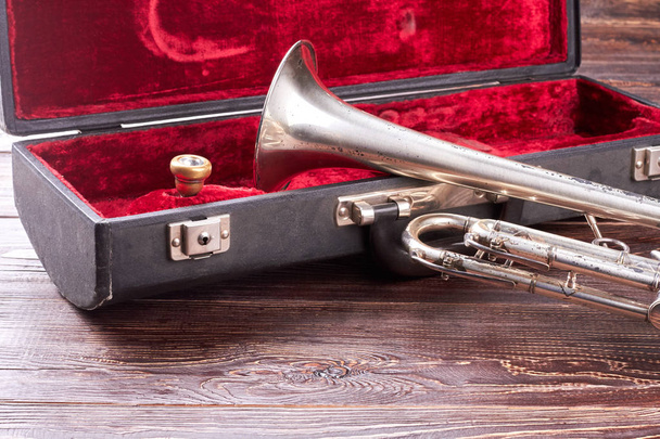 Rusty trumpet and red velvet case. - Photo, Image