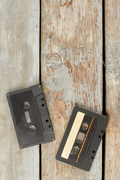 Retro cassette tapes on wooden boards. - Photo, image