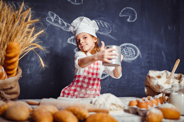 Playful little girl making dough - Фото, изображение