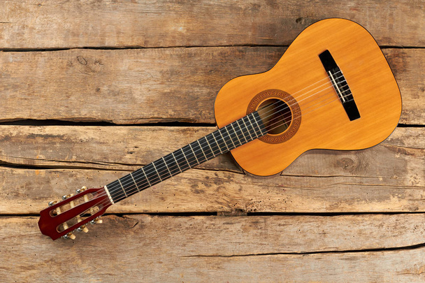 Yellow wooden acoustic guitar. - Photo, Image
