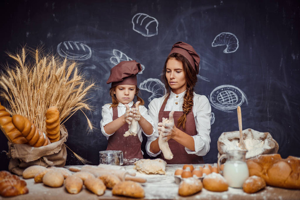 Woman and girl making pastries together - Fotografie, Obrázek