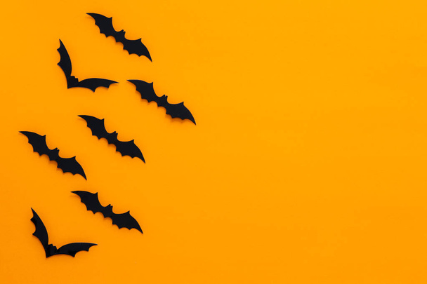 Bats with an orange background. Halloween concept. - Photo, Image