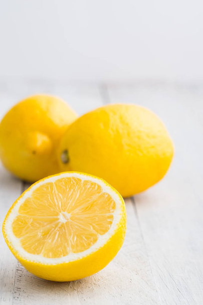 Three lemons on white wooden table. Bright photo. - Foto, Bild