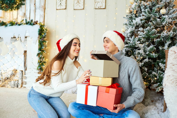 Happy young couple  having fun at Christmas. - 写真・画像