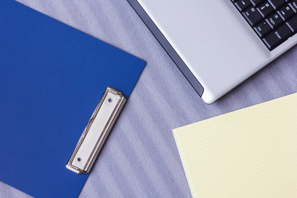 Laptop and notebook on a soft striped plaid, close-up - Fotoğraf, Görsel