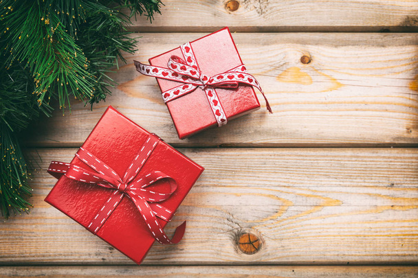 Christmas gift boxes with red ribbons on wooden background, copy space, top view - 写真・画像