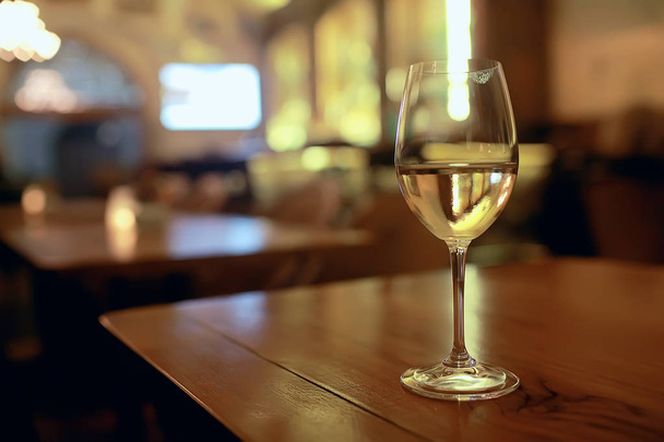 glass of white wine  on table in the restaurant  - 写真・画像
