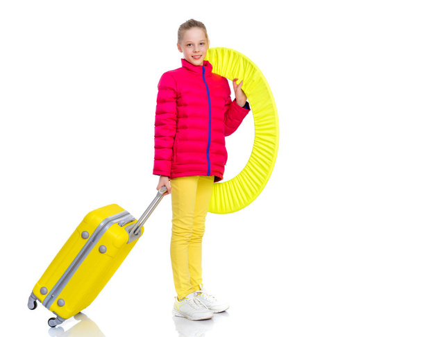 The girl gymnast with a large suitcase goes to the competition. - Fotó, kép