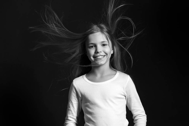 Girl with adorable smile on dark background - 写真・画像