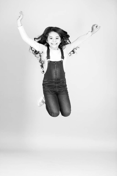 Happy child in jeans overall jump, fashion - Fotoğraf, Görsel