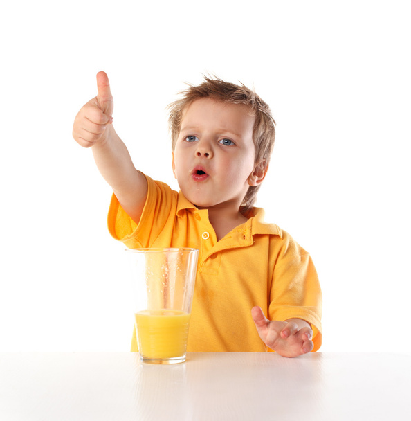 Happy little boy drinking juice - Fotó, kép