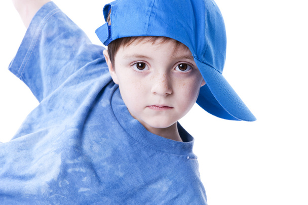 Caucasian little boy in a baseball cap with a blank expression on his face - Foto, afbeelding