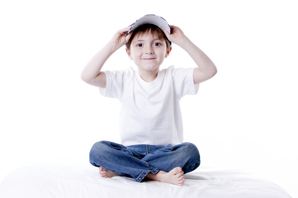 Smiling caucasian little boy adjusting his baseball cap. - Φωτογραφία, εικόνα