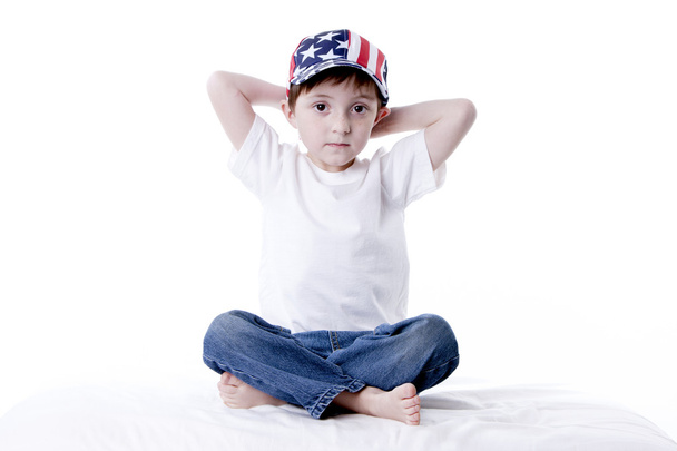 Caucasian little boy wearing a patriotic american baseball cap. - 写真・画像