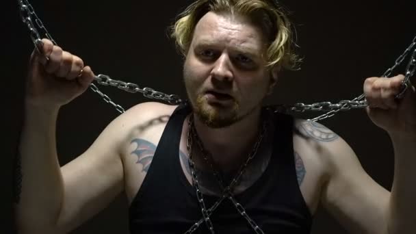 Crazy man bound in chains - Footage, Video