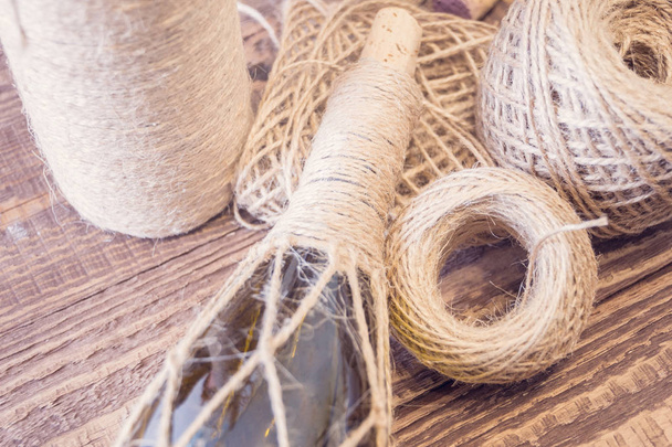 Supplies for decorating a glass bottle. Ecological twine, grue gun and other. Rustic style. Handmade gift for celebrations such as Christmas - Fotoğraf, Görsel
