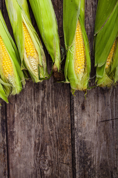 Ripe corn on an old wooden table. Place for your text. - Photo, image