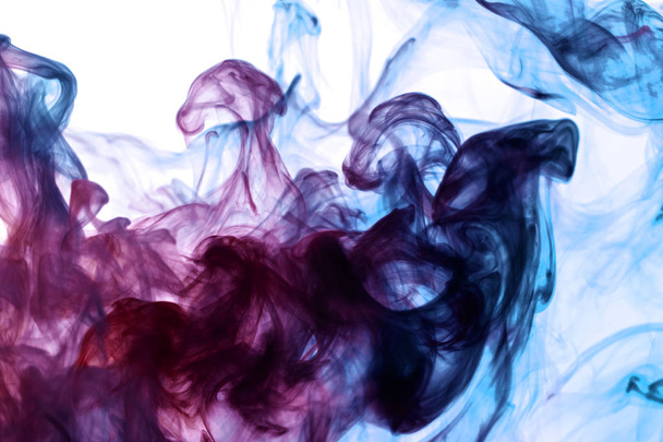 Cloud of pink, red and blue smoke on a white isolated background. Background from the smoke of vap - Фото, изображение